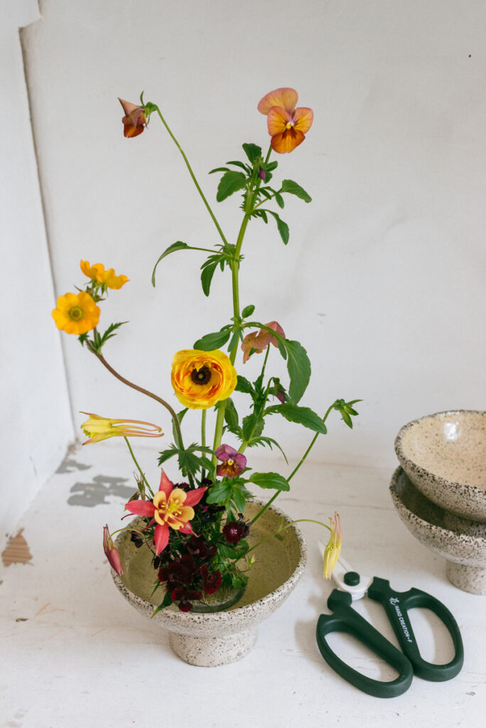 Flower arrangement with spring flowers on a kenzan in Clay Club ceramic vessel, by Wilder Antwerp